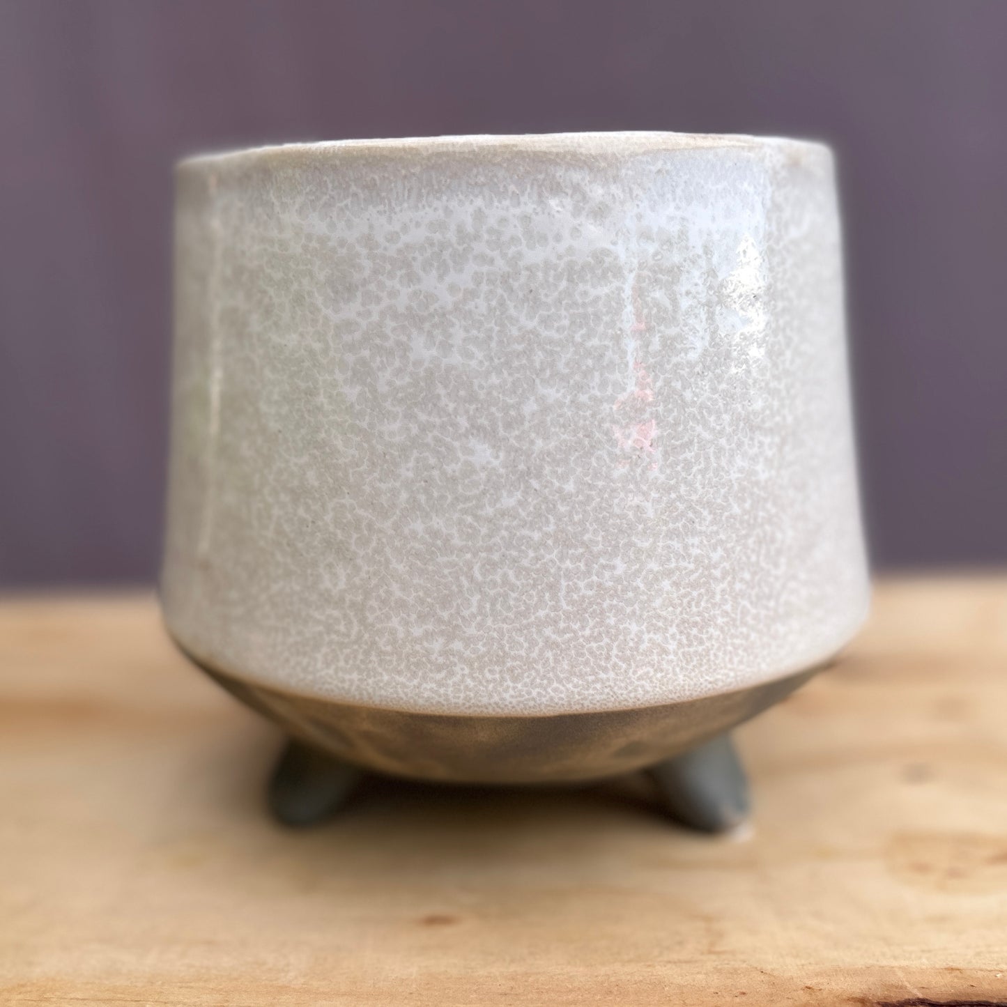 A direct view of the unplanted TV008 Tera-Vessel structural shell. This salvaged architectural ceramic pot features a distinct light speckled top glaze transitioning into a dark base, resting on an integrated tripod foundation as a minimalist Mid-Century Modern decor piece.